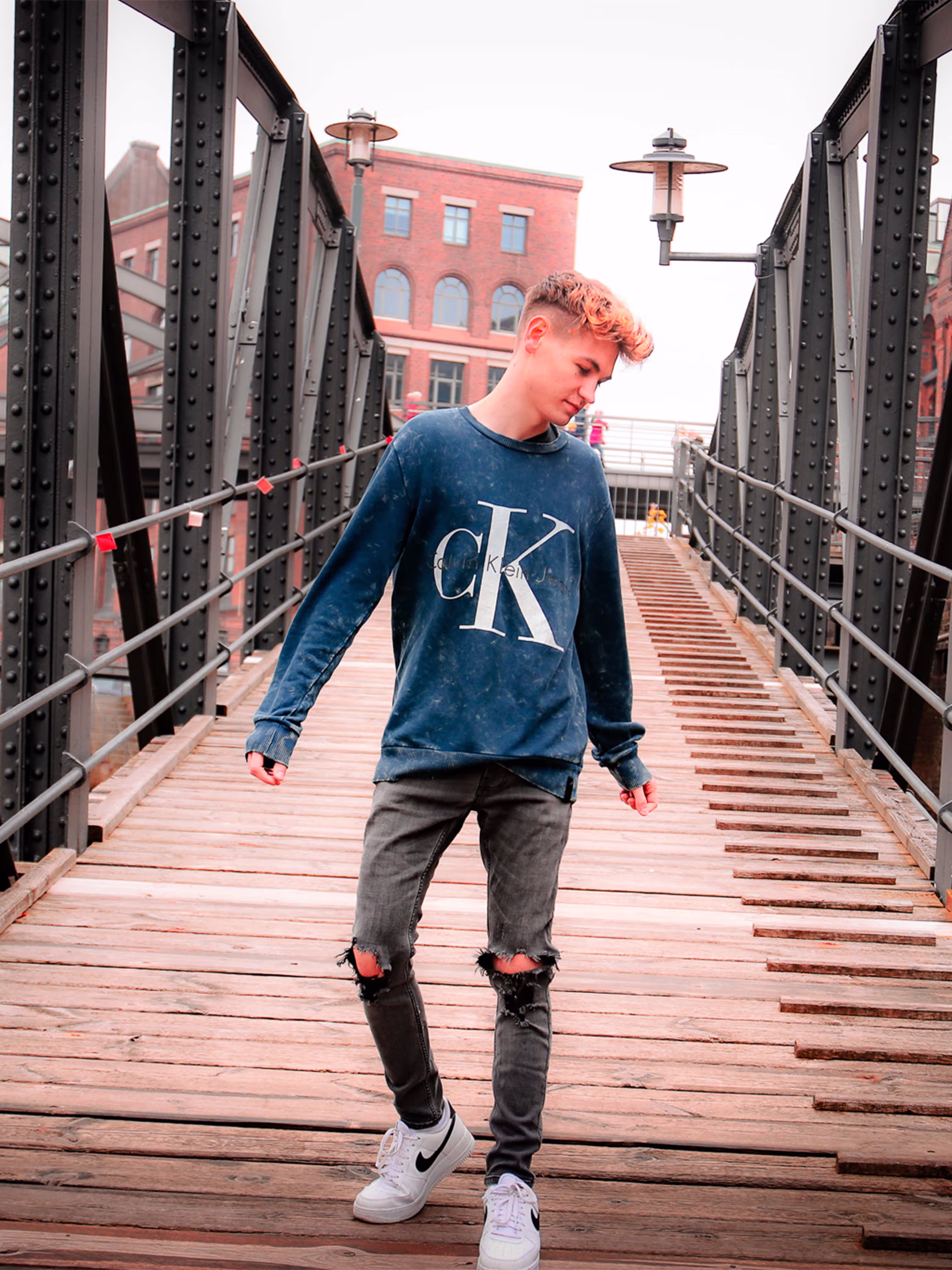 Dylan posing on a bridge.